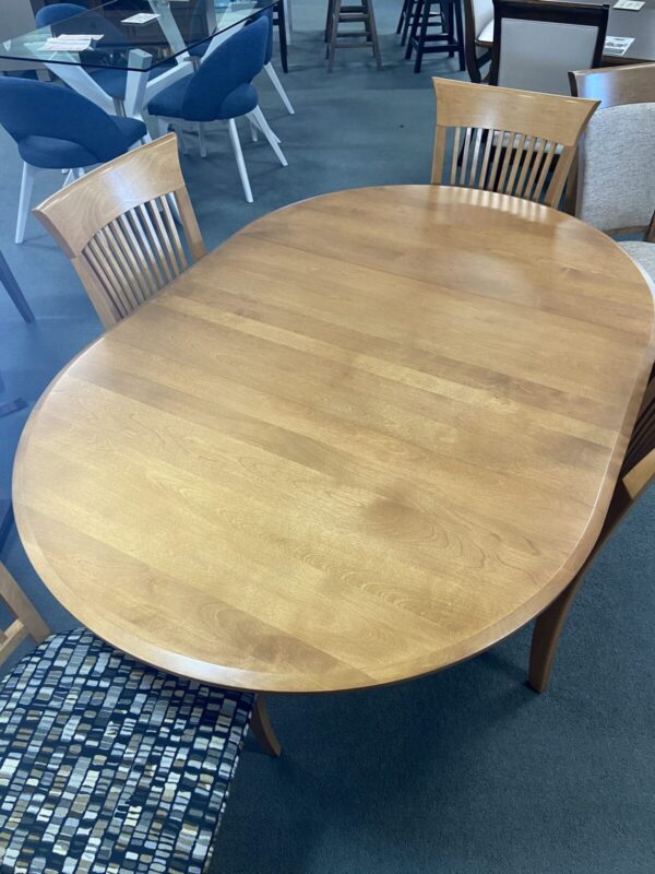 round Birch wood table, oval with leaf leg table with 4 chairs. upholstered seats with slat wood back. Custom options available but this displayed dining set is as is and can be taken home today